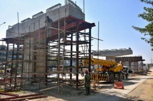Labourers are busy in construction work of flyover at under construction 10th Avenue during development work in Federal Capital.