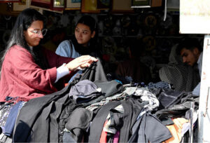 People busy selecting and purchasing second hand clothes from vendor at weekly Bazaar in the Federal Capital.