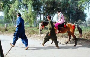 Children enjoy horse riding in National Park.