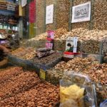 A shopkeeper arranging and displaying dry fruit to attract the customers at Aabpara