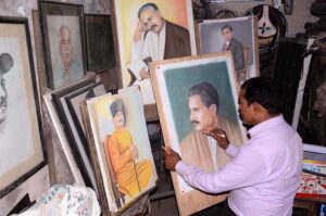 Nation's Poet: An artist gives final touches to a portrait of Allama Muhammad Iqbal ahead of his birth anniversary on Saturday.