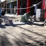 Laborers busy fixing tough tiles on footpath at Aabpara