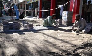 Laborers busy fixing tough tiles on footpath at Aabpara