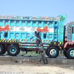 Workers are busy washing the truck at the service station