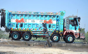 Workers are busy washing the truck at the service station