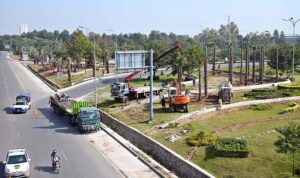 CDA workers busy planting large trees at greenbelt along the 6th Avenue Underpass, Srinagar Highway in the Federal Capital.