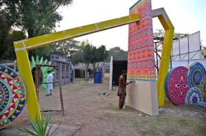 Workers are busy in installation a model of the provincial major cities for the upcoming Folk Festival "Lok Mela 2024" at Lok Versa in the Federal Capital.