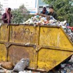 Gypsy youngsters searching and collecting valuables from garbage container at KhannaPul