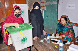 - A woman casting her vote in a polling station during by-election of Local Government UC 51 at Liaqat Colony.