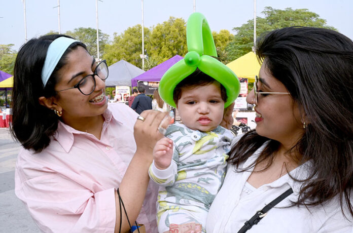 A family in happy mood during visiting the Behbud Art and Craft Bazar 9-10 November at PAK CHINA Friendship center