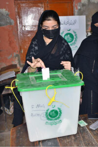 - A woman casting her vote in a polling station during by-election of Local Government UC 51 at Liaqat Colony.