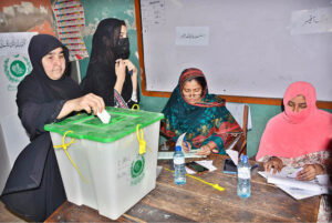 - A woman casting her vote in a polling station during by-election of Local Government UC 51 at Liaqat Colony.