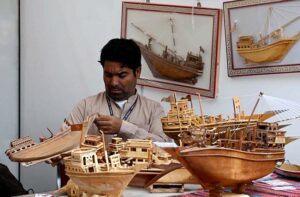 An artist meticulously creates detailed models and miniature ships, turning craftsmanship into art for selling at the 10-day 'Lok Mela,' celebrating provincial culture and folk heritage in the federal capital.