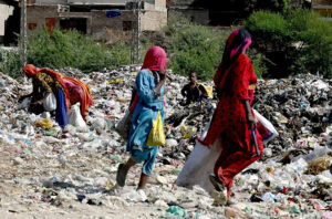 Gypsy women busy searching the valuables items from garbage at site area