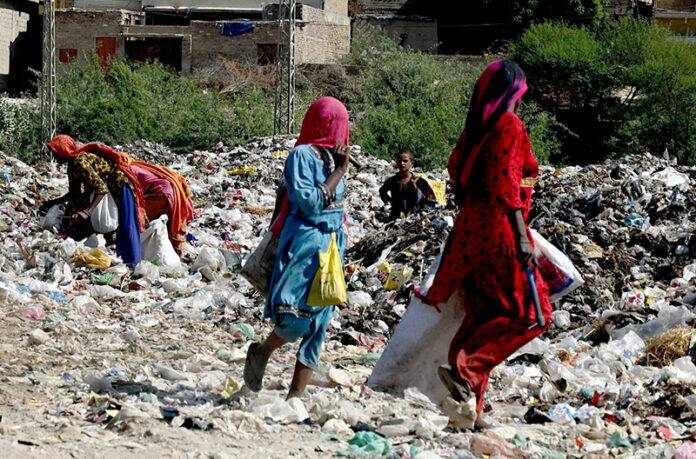 Gypsy women busy searching the valuables items from garbage at site area