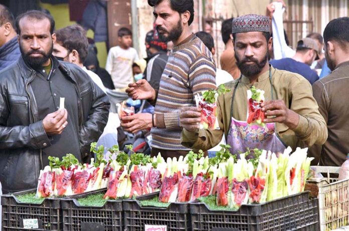 A vendor selling fresh salad on his handcart in a local market of Provincial Capital