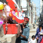 A street vendor selling colorful balloons to attract customers