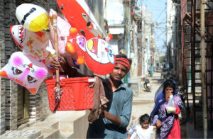 A street vendor selling colorful balloons to attract customers