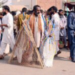 Vendors sell different variety of pigeon-catching nets to attract bird hunters at the bird market