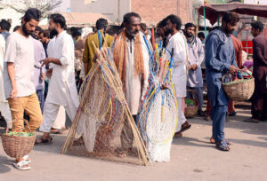 Vendors sell different variety of pigeon-catching nets to attract bird hunters at the bird market