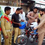 Polio health workers and school scouts administer polio drops to young children at Farid Gate in the city, in efforts to eradicate polio in Pakistan