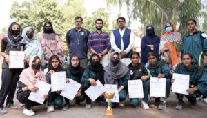 A Group photo of Director Sports Education Board Roshan Zameer Kalro with students of Govt Girls College Khushab after taking 2nd position During Intercollegiate Girls Volley ball tournament at Government Graduate College for Girls, Chandni Chowk
