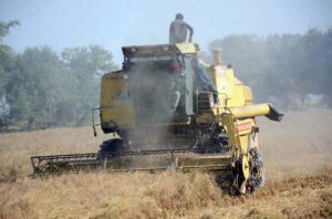 Farmers preparing his field with the help of a tractor for the wheat crop.