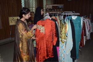 Women exploring the handicraft stalls at the Dastkari Exhibition at Qasr-e-Behbood