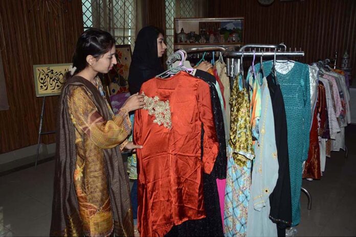 Women exploring the handicraft stalls at the Dastkari Exhibition at Qasr-e-Behbood