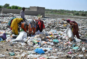 Gypsy women busy searching the valuables items from garbage at Latifabad.