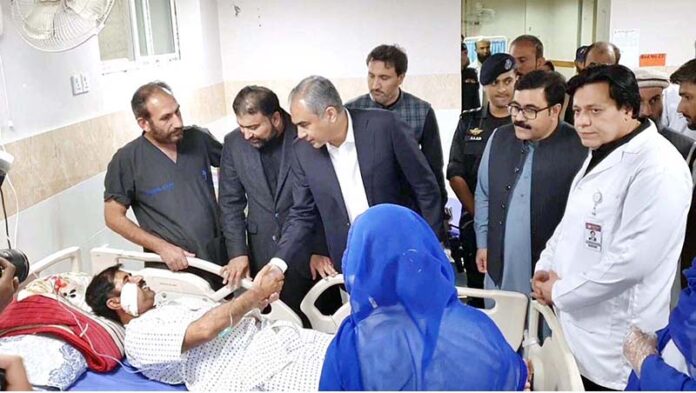 Federal Minister for Interior Mohsin Naqvi along with CM Balochistan Sarfraz Bugti inquiring about the health of the injured person in Railway Station blast at Civil Hospital