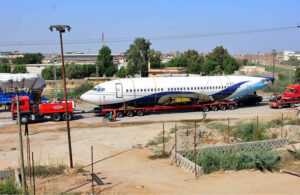 A heavy trailer transports a retired Boeing 737 airplane from Karachi to Hyderabad Airport