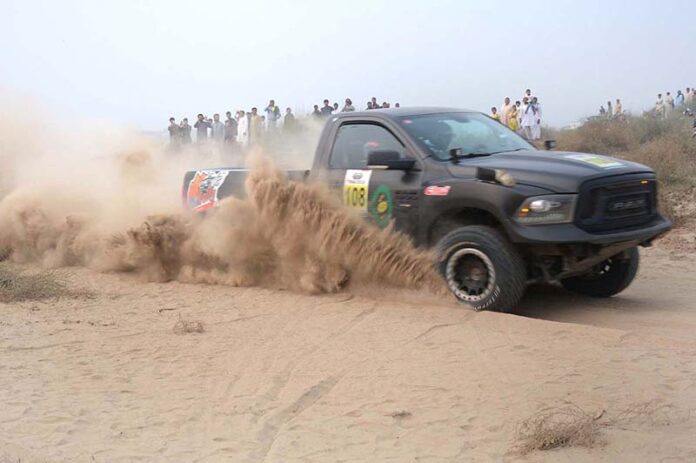 A racer showcases his skills in the final round of the 9th Thal Desert Jeep Rally organized by the Tourism Development Corporation of Punjab