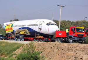 A heavy trailer transports a retired Boeing 737 airplane from Karachi to Hyderabad Airport