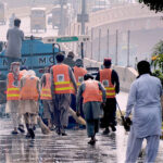 Workers of the waste management company washing the roads during the Clean Punjab Campaign