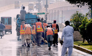 Workers of the waste management company washing the roads during the Clean Punjab Campaign