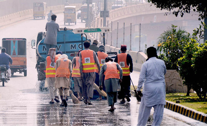 Workers of the waste management company washing the roads during the Clean Punjab Campaign