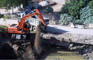 Heavy machinery is being utilized for construction and development tasks during the expansion of the service road in the Federal Capital