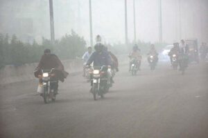 Vehicles navigate through dense smog, highlighting the deteriorating air quality and the serious health risks it poses to locals.