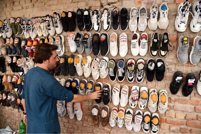 A vendor displaying used shoes to attract the customers near Jinnah Bagh Chowk
