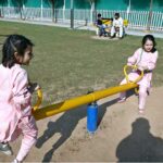 Children are enjoying playing on a seesaw in a local park in the Federal Capital