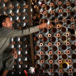 A vendor arranges and displays upper parts of the traditional smoking Hookah (chilam) at his shop in the provincial capital