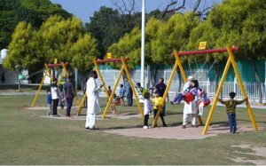 Children are enjoying playing on a seesaw in a local park in the Federal Capital
