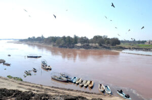 Boats parked along the bank of River Ravi, create a tranquil scene in the provincial capital.