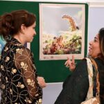 Visitors watching the photo exhibition on the occasion of the "People's Unity Day" ceremony held at the Consulate General of the Russian Federation