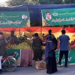 People buying fruits from stalls at Sahulat Sasta Bazar, organized by the Punjab government