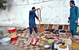 A vendor displaying dry fruit on the footpath to attract customers.