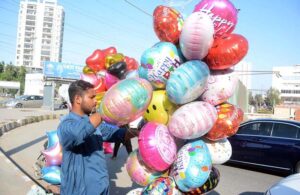 A street vendor sells colorful balloons to attract customers in the Clifton area