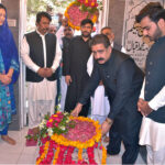 Deputy Commissioner Muhammad Zulqarnain Langriyal is laying floral wreaths on the graves of the parents of Allama Muhammad Iqbal
