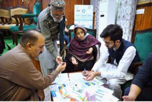 Diabetic doctors examine patients at a free diabetes medical camp for journalists and their families at the Press Club in Peshawar.
